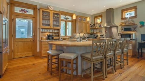 Kitchen with a curved island and bar stools.