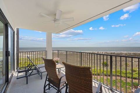 This private balcony overlooks coastal dunes and a glimpse of the Atlantic beyond—an easy spot for morning coffee or evening breezes.