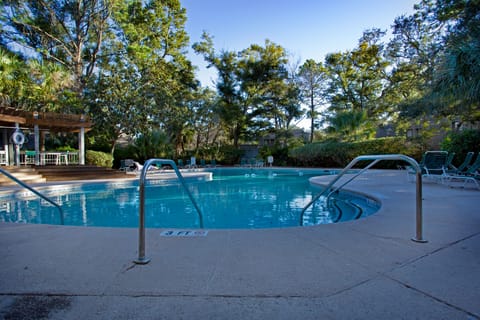 Surrounded by plenty of lounge chairs, shaded seating, and lush Lowcountry landscaping, the expansive pool provides ample space for swimming and unwinding.