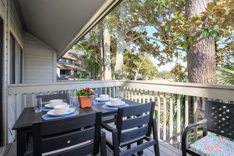 Elevated and shaded, the porch feels tucked away yet open—perfect for enjoying fresh air and the quiet rhythm of the course beyond.