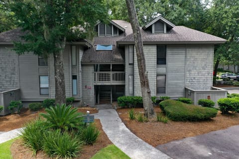A central, covered entryway provides easy access, while the peaceful setting creates a private, residential feel.
