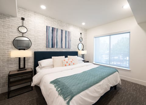 King Bed outfitted with luxury bedding atop a supportive Tuft & Needle mattress.