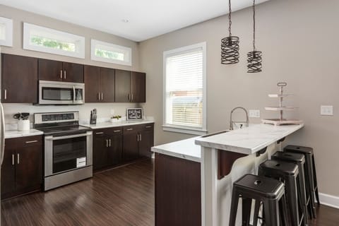 Fully equipped kitchen with additional seating. 