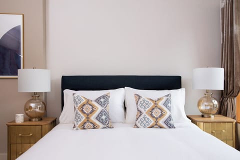 Bedroom with large bed and two side tables 