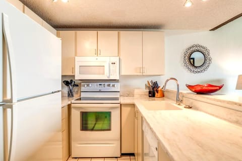     Cozy Kitchen with Classic White Appliances and Marble Countertops
