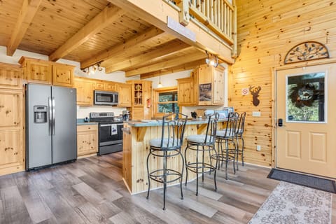 Fully stocked kitchen with newer appliances and seating for 4 at the island.