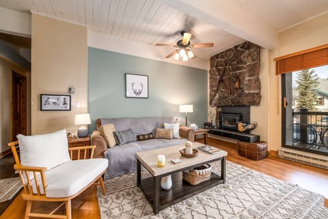 Warm mountain retreat with rustic charm — cozy fireplace, comfy seating, and natural light for the perfect relaxing escape.