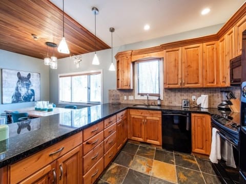 Large well stocked kitchen, with dining area adjacent.