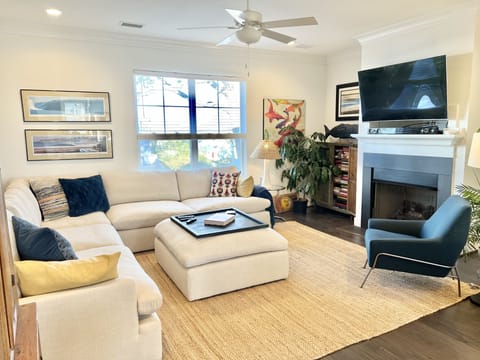 Open floor plan with large sectional seating and big screen smart tv