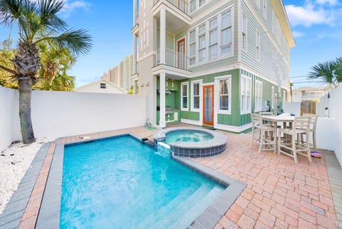 Step into your private paradise with sparkling pool, hot tub, and tropical palms creating the perfect outdoor retreat.