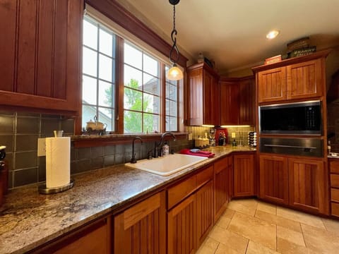 The kitchen boasts high-end appliances and a food-warmer under the microwave