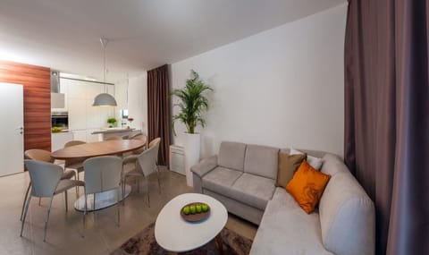 Living room with a  sofa, dining area and a fully equipped kitchen on the ground floor of a Croatia luxury modern villa  Trogir 2 with pool
