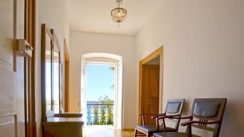 Hallway with a sitting area and a mirror with a view of the sea in a private pool villa for rent in Orebic Croatia