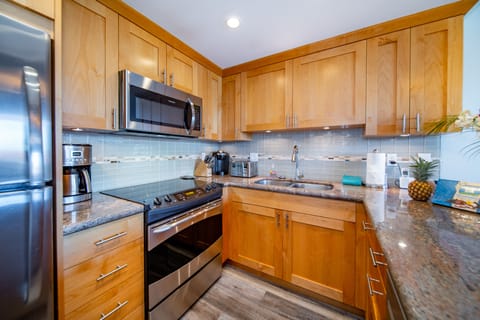 Beautifully renovated kitchen with ample cookware and flatware.