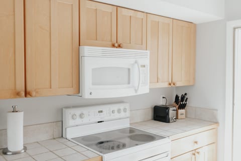 Functional kitchen with plenty of plates, cooking utensils, and serving trays