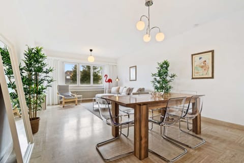 Elegant dining area with contemporary furniture and plenty of natural light, perfect for family meals and gatherings.
