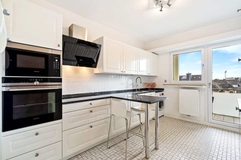 Spacious and well-equipped kitchen with sleek design, ideal for culinary enthusiasts and long-term stays.