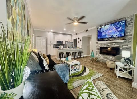 open concept living room and dinning room kitchen with lovely fireplace wall