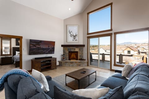 Beautiful living area with, high ceilings, gas fireplace, smart tv, and views of the Continental Divide.