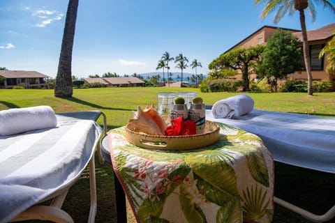 Indulge in lawn lounges set with drinks, fruit, and sky.