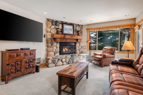 Snow Flower 20 offers a cozy living room with gas burning fireplace with stone surround and leather furnishings.