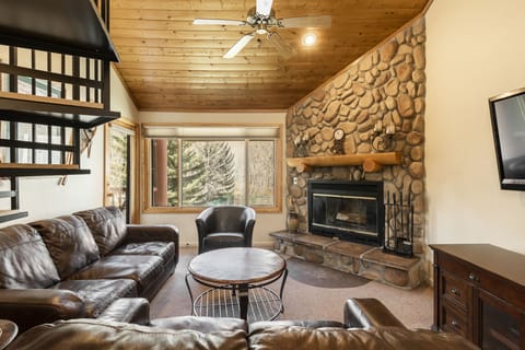 The cozy living room with river stone fireplace.