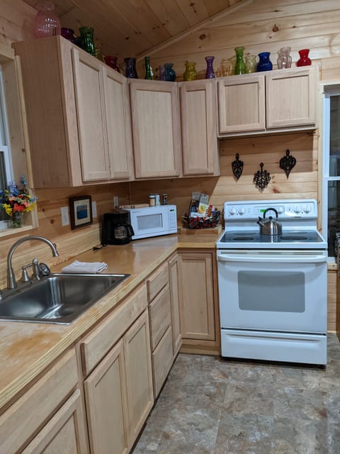 Kitchen with stove, oven, microwave, refrigerator, freezer and cookware