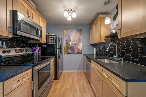 Kitchen updated with maple cabinets and leathered granite counters