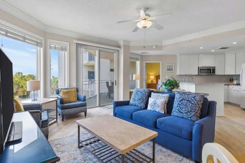 Bright living area with blue accents and access to a balcony.