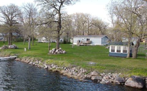Water view of cabin, bahrzebo, and yard 
