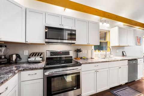 The kitchen is fully equipped with modern stainless steel appliances, offering everything you need to prepare delicious meals.