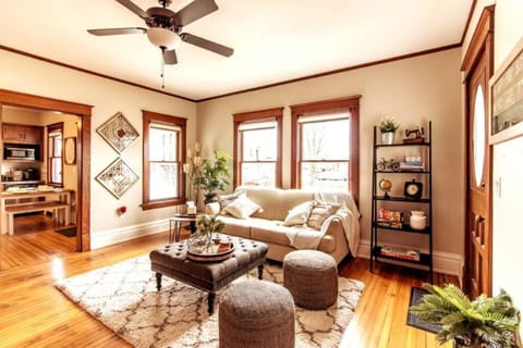 Welcome to the inviting downstairs family room flooded with natural light. This spacious area is perfect for spending quality time with loved ones. Discover a cozy reading bench and enjoy entertainment on the smart TV.