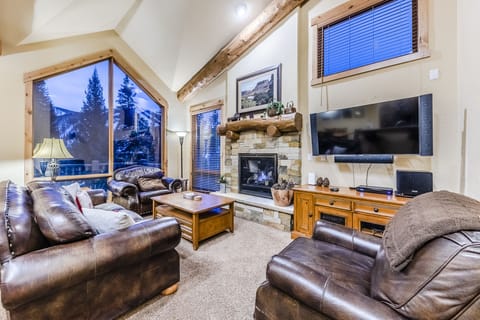 Living Area - Grand living area with large windows offering plenty of natural light and spectacular views. Leather furniture, gas fireplace, flat screen TV.