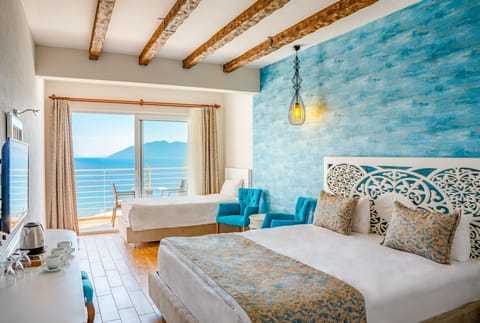 Standard Triple Room, Sea View | Pillowtop beds, minibar, in-room safe, desk