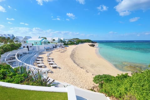 On the beach, white sand, beach umbrellas, beach towels