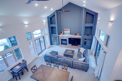 Bright, open living room with amazing views of the golf course and mountains.