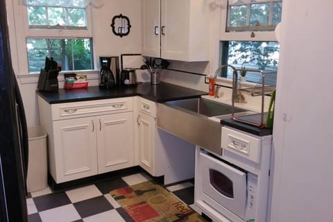 Honed Granite Countertops with $1100 Stainless Steel Farmsink in this updated kitchen. Open area underneath sink was designed as a pet feeding station. Pico Remote control at the back door runs the Welcome Home Scene, Relax Scene and All Off Scene. Never walk in the dark in this Townhome!    