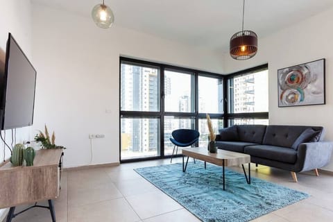 Bright living room with large windows creates a welcoming space to relax after nearby beach walks.