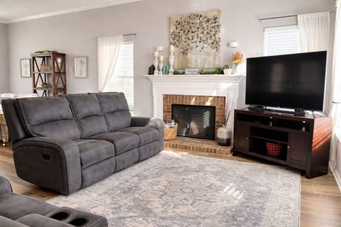 Large living room where everyone can gather around watching on a Smart Tv.