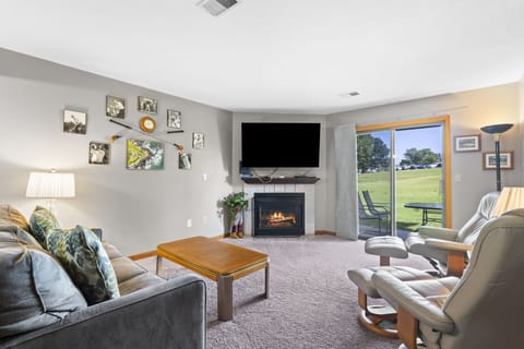 Comfortable living area with sofa bed, Cable TV, and Patio Access.