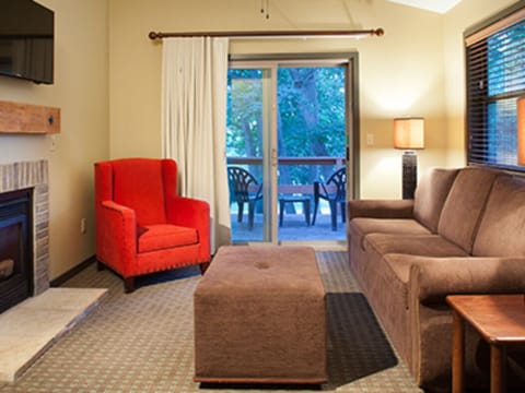 LIving room with fireplace and patio.