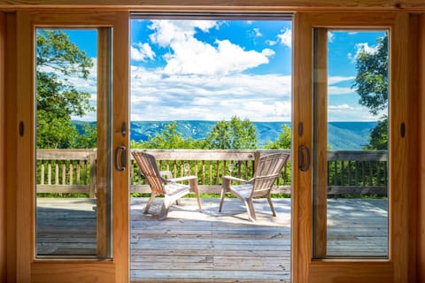 Relax on the wooden deck with mountain views framed by sliding glass doors.