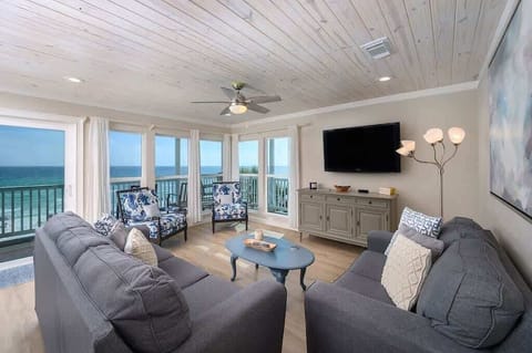 - Huge windows fill the room with natural light & offer nonstop views of the ocean - Soft couches, patterned chairs, & a ceiling fan create a relaxed, breezy setting - Ocean views from every seat make it easy to unwind or catch a movie together