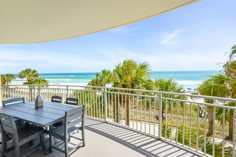 Dine al fresco on your private balcony with stunning ocean views, swaying palms, and endless turquoise waters stretching to the horizon.