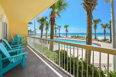 Relax in your turquoise chairs while soaking up stunning ocean views from your private balcony overlooking tropical palms and pristine beach.