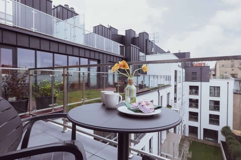 Furnished balcony with green surroundings. 