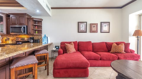 Inviting red sofa commands the living room