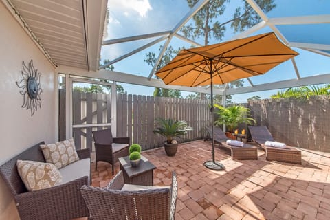 PV129 - The covered lanai and screened back patio offer complete privacy and are great for lounging and entertaining and feature a BBQ, a dining area, a seating area and lounge chairs!