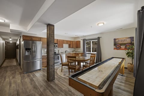 18' Championship Shuffle Board Table and Open Concept Living With Chef’s Kitchen, Full Dining Area And Cozy Lounge