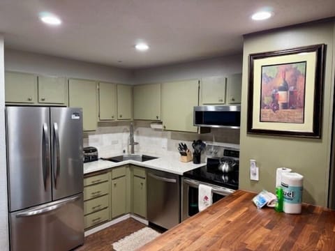 Kitchen - Stainless steel appliances. Butcher block island.